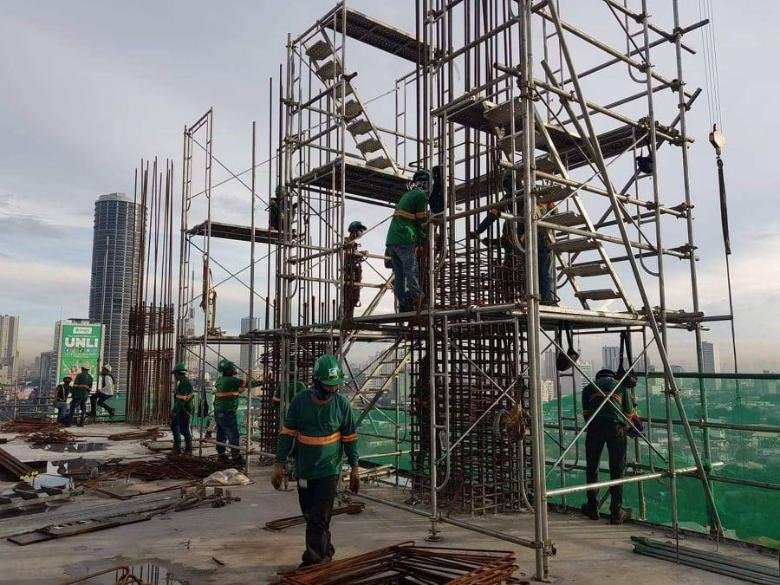 CADCOR crew members working on scaffolding at a high-rise construction site