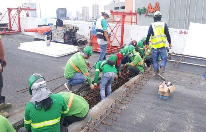 CADCOR crew members pouring concrete on a bridge deck