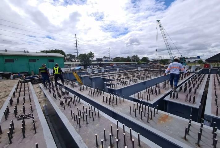 Steel unibridge segment being placed by crane barge